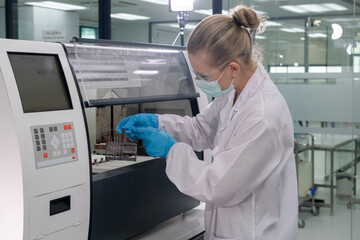 Scientist operates laboratory equipment while conducting research in a modern lab setting