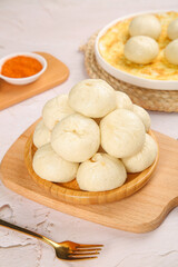 Steamed Xiaolongbao Dumplings on Wooden Plate with Sauce Traditional Chinese Dim Sum Cuisine