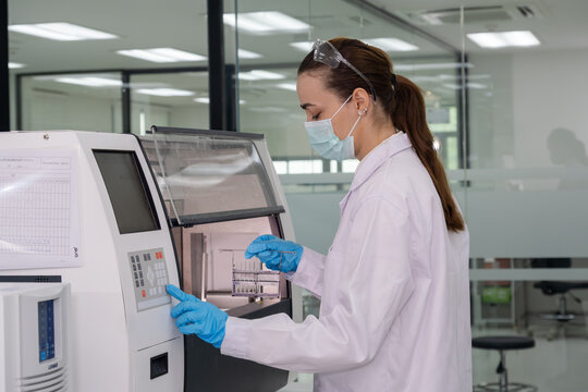 Scientist conducts laboratory analysis in modern facility with advanced equipment