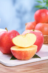 Fresh Red Fuji Apples from Aksu Xinjiang on White Display Board with Sliced Apple