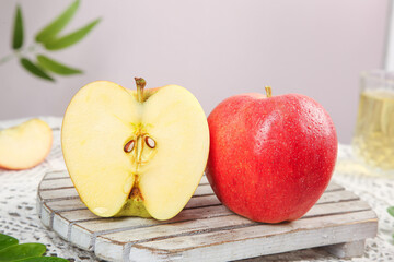Fresh Red Apple Cut in Half Showing Seeds on Wooden Board - Healthy Fruit Concept