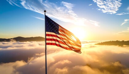 American flag waving over clouds at sunrise