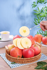 Fresh Red Gala Apples from Aksu Xinjiang in Wicker Basket with Sliced Fruit and Tea Cup
