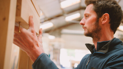 Close Up Of Carpenter In Workshop Building Wooden Window Frame