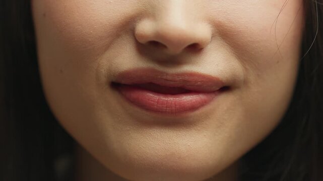 Close up face part Asian woman unrecognizable girl grimacing showing tongue funny grimace lady having fun fooling joyful plump lips female mouth beauty filler injection cosmetology dermatology skin