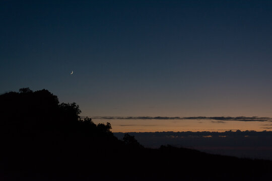 Crescent Moon over Hill Silhouette at Twilight