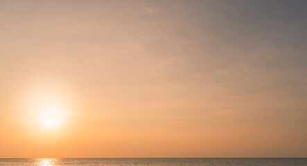 Golden Sunset sky background in the Evening with Orange, Yellow romantic gold nature sunlight clouds and dramatic colorful fluffy cloud,Horizon landscape sun sea summer beautiful sunrise sky,Dusk sky