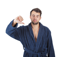 Displeased and sleepy young man hates waking up early morning. Fatigue male portrait, wearing bathrobe, shows thumb down negative gesture isolated on transparent background