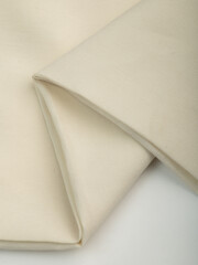 Light, dense fabric for sewing clothes, ironed, the texture of the fabric is visible