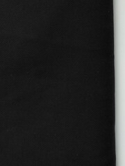 Dark dense fabric for sewing clothes, ironed, the texture of the fabric is visible