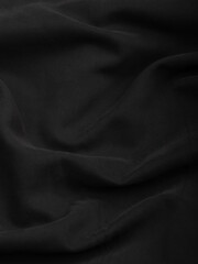 Dark dense fabric for sewing clothes, ironed, the texture of the fabric is visible
