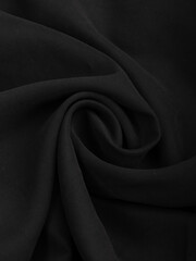 Dark dense fabric for sewing clothes, ironed, the texture of the fabric is visible