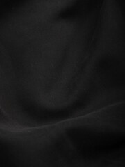 Dark dense fabric for sewing clothes, ironed, the texture of the fabric is visible
