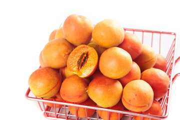 Fresh Xinjiang Apricots in Red Shopping Basket - Ripe Orange Stone Fruits Display