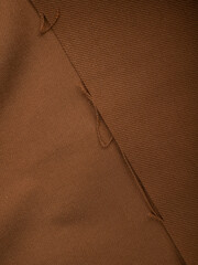 Dark dense fabric for sewing clothes, ironed, the texture of the fabric is visible
