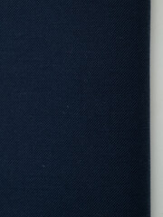 Dark dense fabric for sewing clothes, ironed, the texture of the fabric is visible