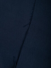 Dark dense fabric for sewing clothes, ironed, the texture of the fabric is visible