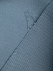 Light blue dense fabric, ironed, the texture of the fabric is visible