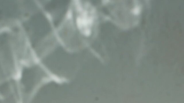 The reflection of water on a white wall.