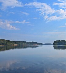 Calm river with forest and blue sky