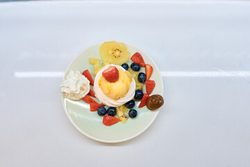 Delicious pavlova cake with fresh fruits and whipped cream topping