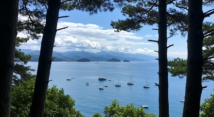 Scenic view of a calm blue bay with sailboats framed by pine trees and distant mountains under a partly cloudy sky