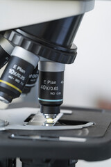 Microscope objective lens focused on sample slide