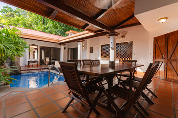 Covered patio with dining table and private pool in vacation home