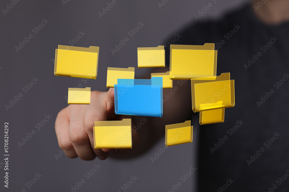 Poster hand interacting with digital folders, representing data organization and management.