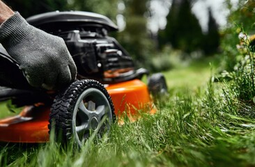 Fototapeta premium Lawnmower in Operation: A Close-Up of Mowing Lush Green Grass for Garden Maintenance and Landscaping