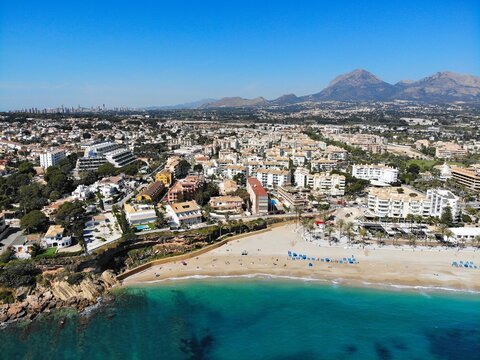 Beach town El Albir in Alfaz del Pi municipality of Alicante Province, Valencian Community in Spain. Costa Blanca region holiday town. Drone point of view in April.