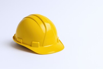 Fototapeta premium Yellow Hard Hat Isolated on White Background, Essential Protective Gear for Construction and Industrial Safety