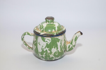 Close up of a typical Indonesian enamel cup isolated on a white background. The iron cup is green...