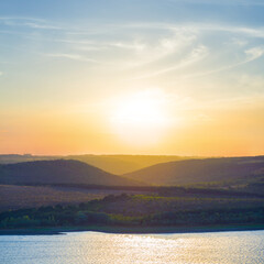 view from above to the wide river at the sunset