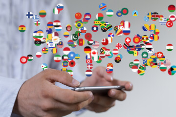 Image of hands holding a smartphone with many flags representing global connections and communication.