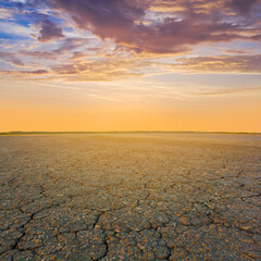 dry cracked saline land at the dramatic sunset
