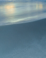 Soft wave on the sandy beach as a background. 
