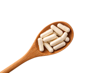 Multiple white capsule medications scattered randomly on a wooden spoon in casual arrangement, isolated on a transparent background