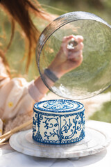 Delicious and elegant cake in tender hands,celebration concept. Dining al fresco, perfect for...