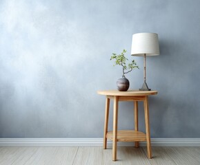 A light-toned wooden side table with a cream-colored lamp and small bonsai plant sits against a textured, muted blue wall.