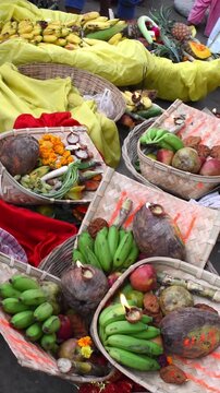 Chhath Puja dala or basket on a river bank for worship God Sun, bamboo baskets with banana, thekua, coconut, diya, flower and other puja items. vertical video
