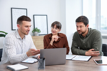 Couple having meeting with business consultant at table in office