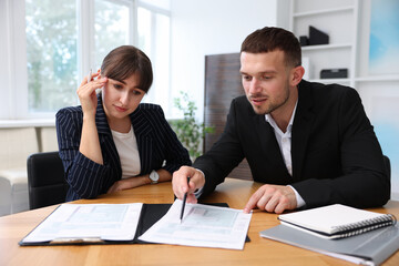 Consultant working with client at table in office. Business meeting