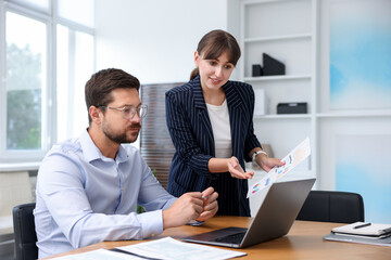 Consultant working with client at table in office. Business meeting