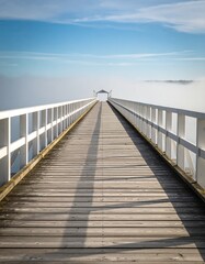 Naklejka premium Wooden pier extending into a fog