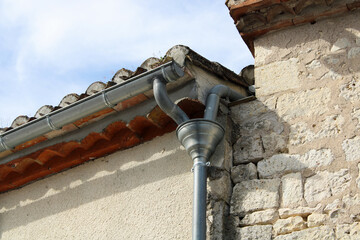 zinguerie, cuvette demi-ronde de branchement zinc sur la façade de la maison