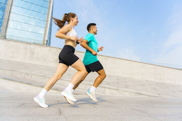 Couple enjoy a jog outdoors in urban Park