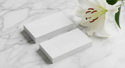 Elegant white business cards mockup featuring a pristine white lily flower on a marble background perfect for branding and stationery design