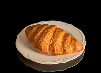 Chocolate croissants isolated on black background, close-up.