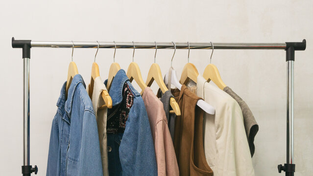 Collection of upcycled second-hand denim and fashion pieces displayed on a rack. Eco thrifting life.